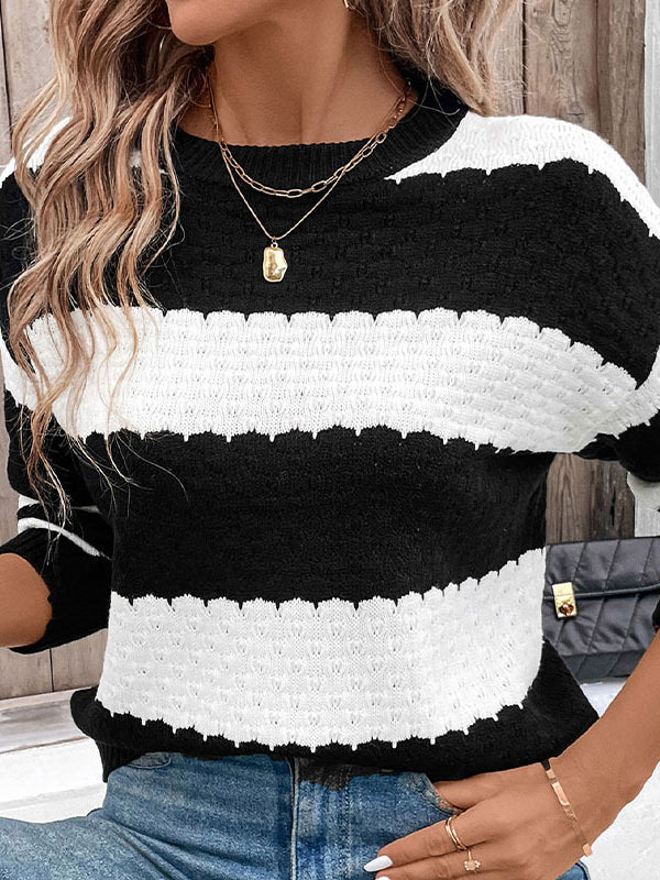 Person wearing a black and white striped sweater with a blurred background