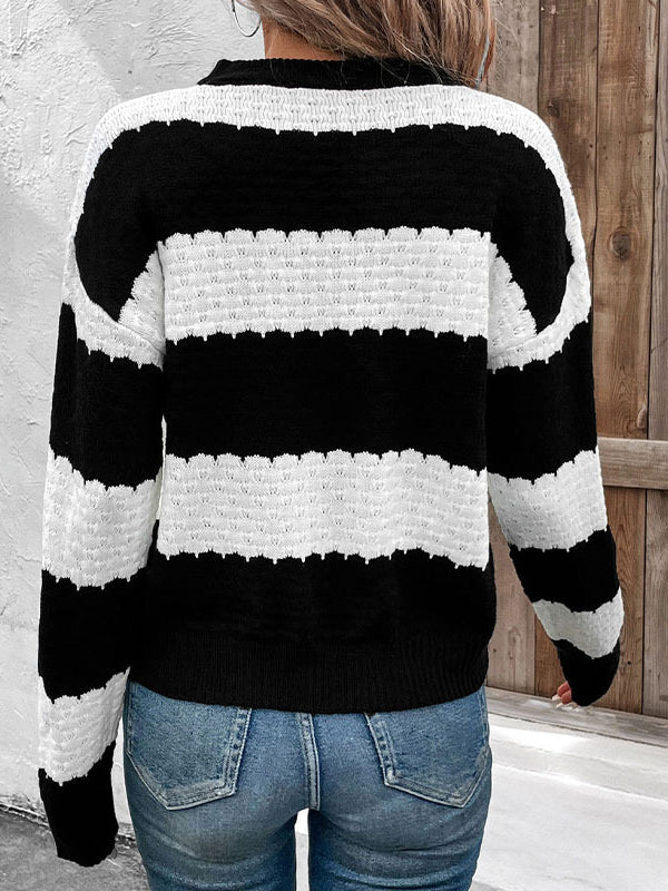Black and white striped sweater worn by a person with a wooden background