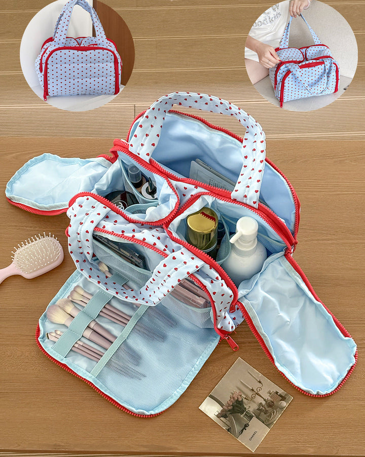 Makeup bag with red polka dot trim on a wooden surface, containing various cosmetic items.