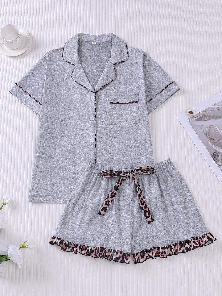 Gray pajama set with leopard print details on a white background