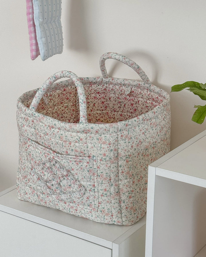 Floral-patterned storage basket on a white surface with a neutral background