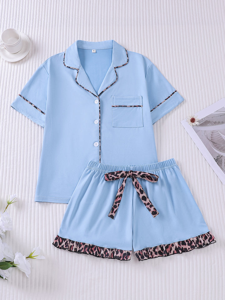 Light blue pajama set with leopard print details on a white background