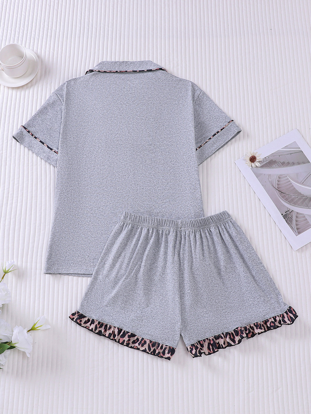 Gray pajama set with leopard print trim on a white background