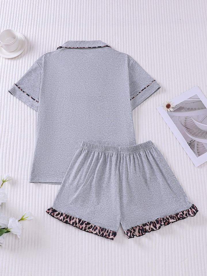 Gray pajama set with leopard print trim on a white background