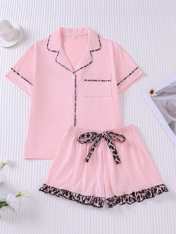 Pink pajama set with leopard print details on a white background