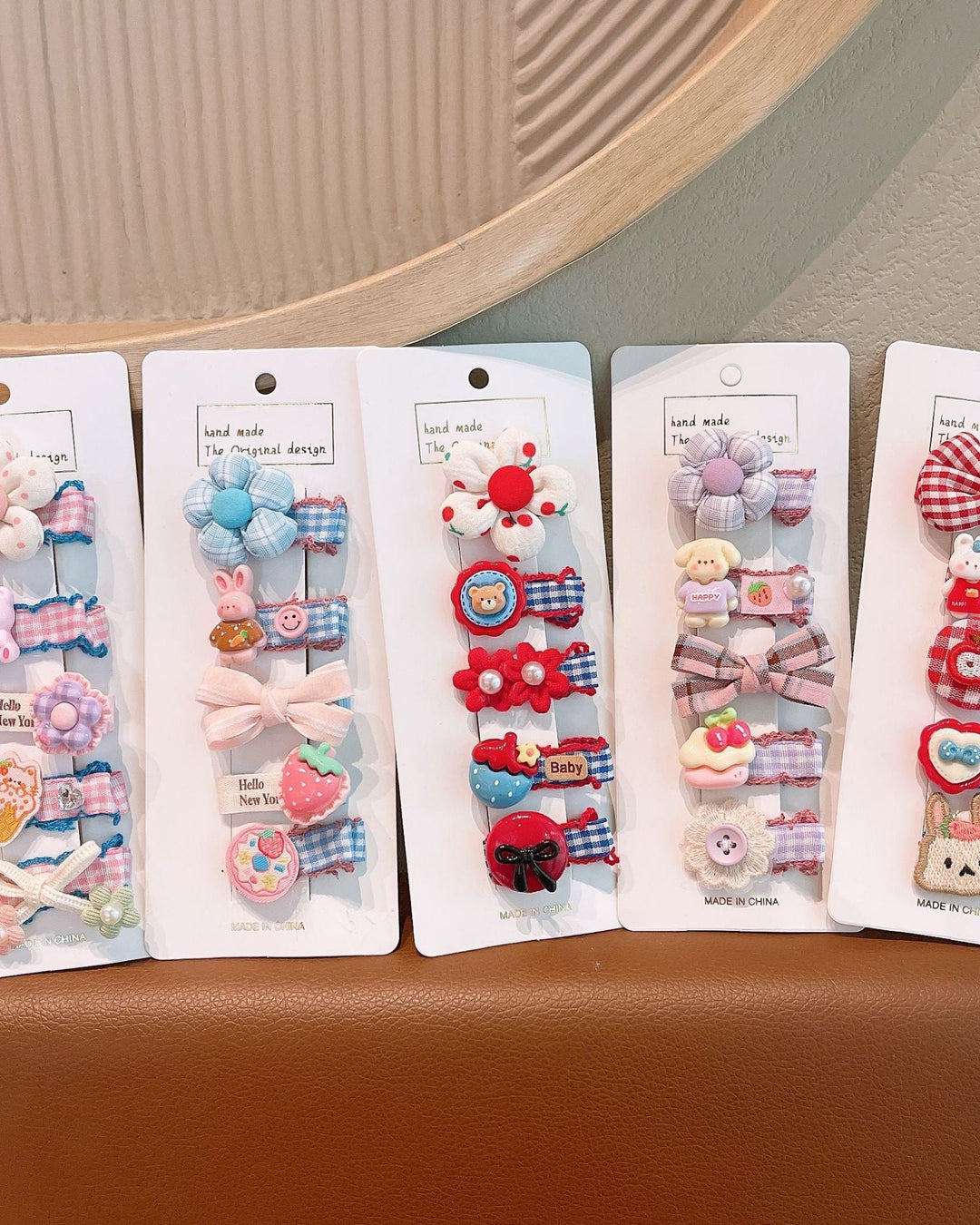 Set of colorful hair clips in packaging on a brown surface