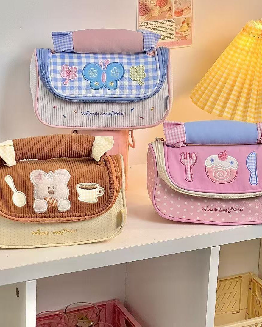 Three children's bags with cute designs on a shelf.