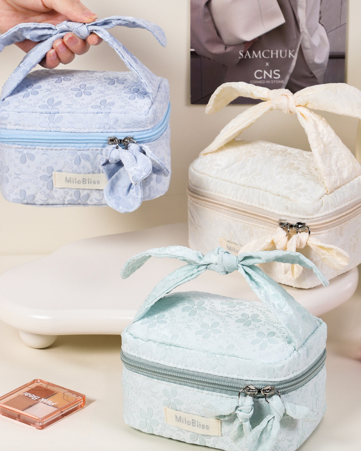 Three small, decorative bags with ribbons on a light background
