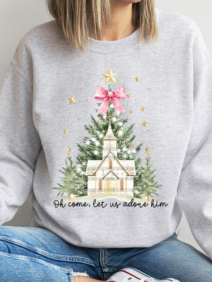 Gray sweatshirt with Christmas-themed design featuring a church and tree, worn by a person.