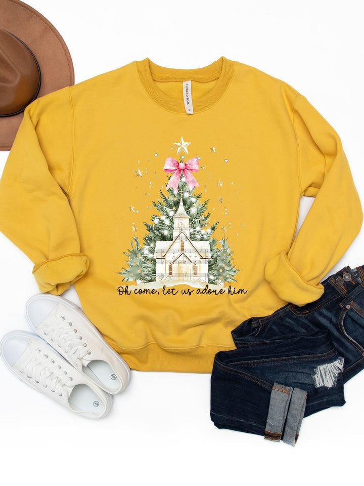 Yellow sweatshirt with Christmas tree and church design, paired with white sneakers and denim shorts on a white background.